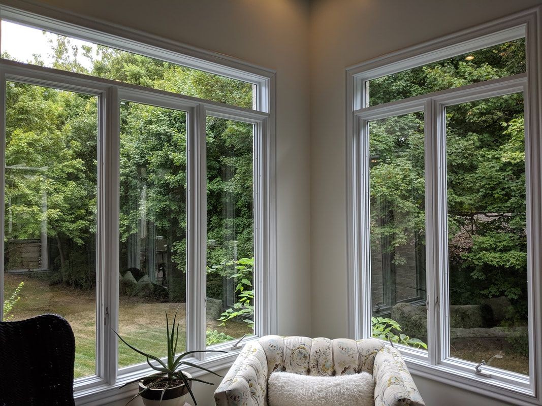 Technician performing professional window cleaning in Michigan.